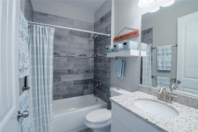 bathroom featuring toilet, shower / bath combo with shower curtain, vanity, and a textured wall