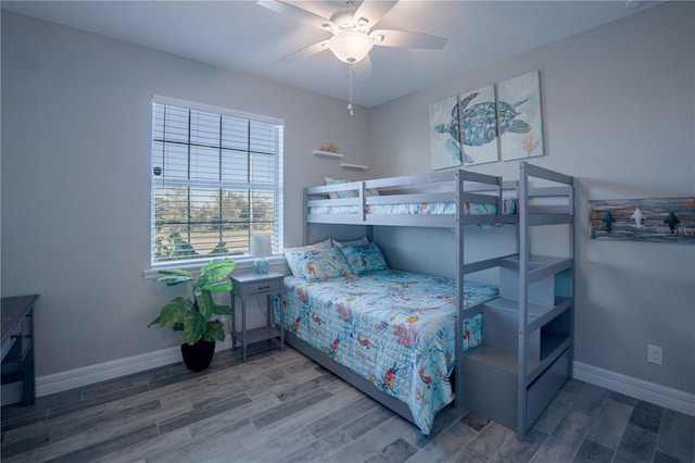 bedroom featuring wood finished floors, baseboards, and ceiling fan