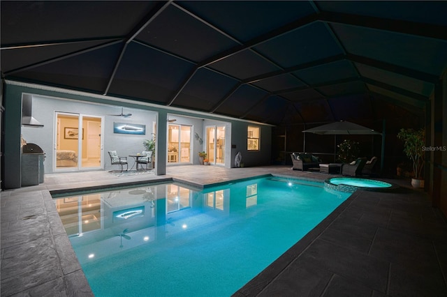 view of swimming pool with glass enclosure, a patio, and a pool with connected hot tub