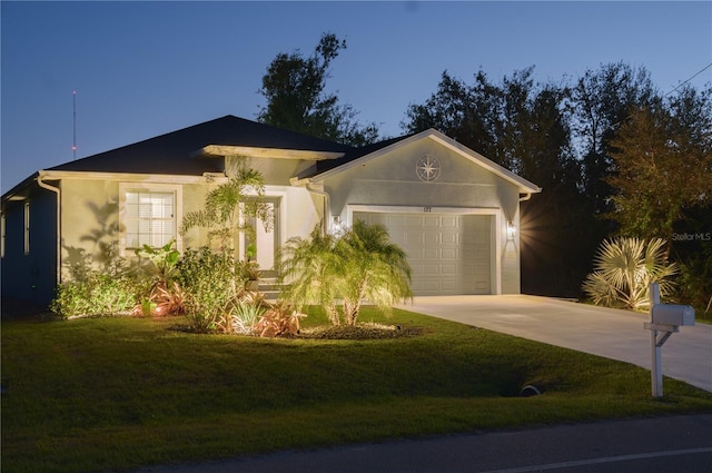 view of front of home featuring stucco siding, concrete driveway, and a front yard