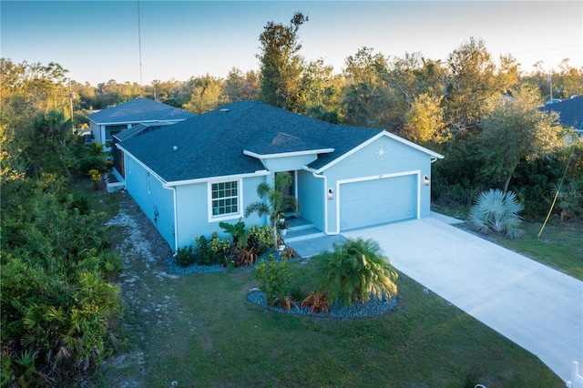 ranch-style house featuring a front yard, a garage, driveway, and stucco siding