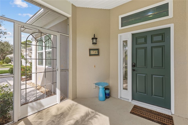 view of exterior entry featuring stucco siding