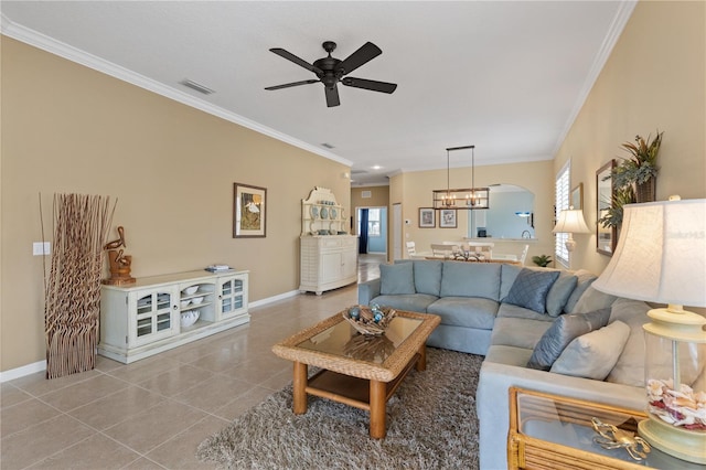 living area featuring crown molding, visible vents, ceiling fan, baseboards, and tile patterned floors