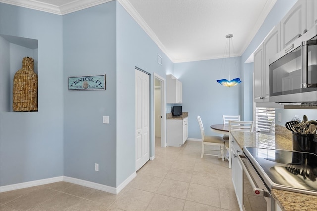 kitchen with light tile patterned floors, white cabinetry, ornamental molding, and stainless steel appliances