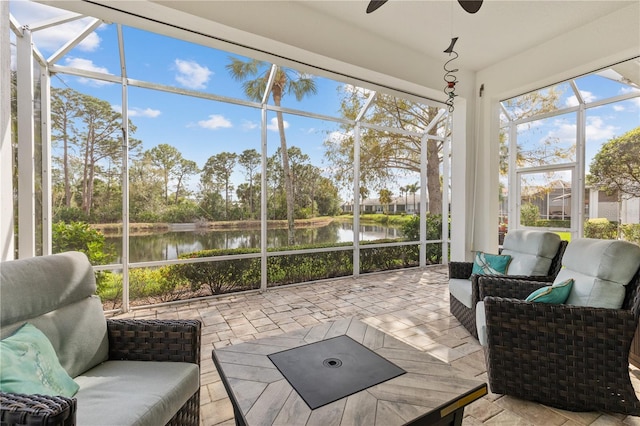 sunroom with a water view and a ceiling fan