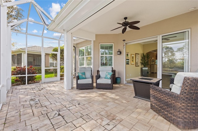 sunroom / solarium featuring a ceiling fan