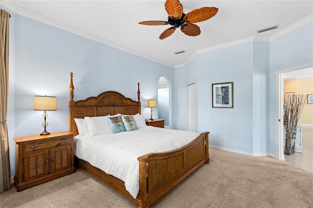 bedroom with crown molding, visible vents, and light colored carpet