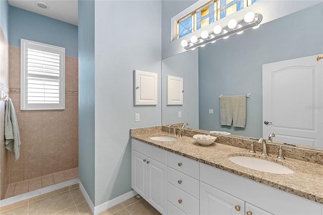 bathroom featuring a healthy amount of sunlight, a sink, and a walk in shower