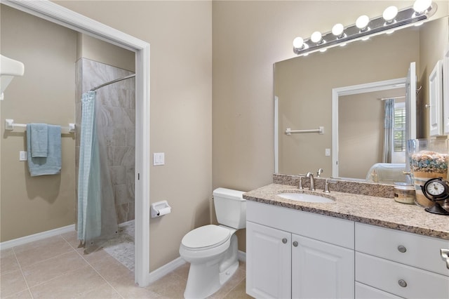 bathroom featuring toilet, tile patterned flooring, a tile shower, and vanity