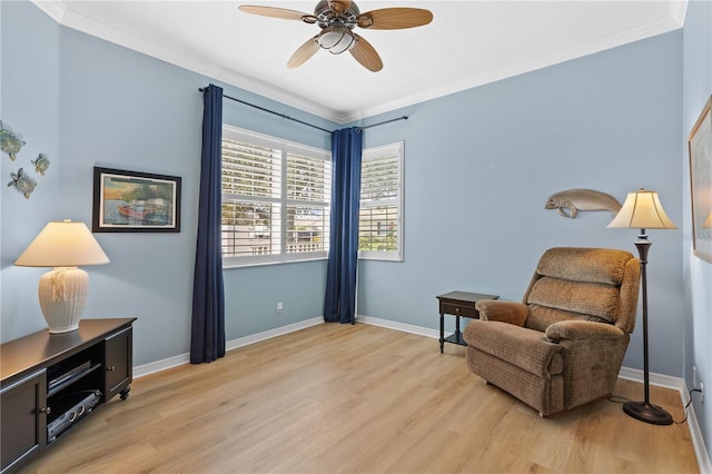 living area featuring light wood-style floors, ornamental molding, baseboards, and ceiling fan