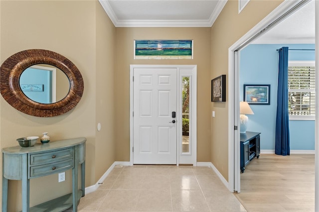 foyer entrance featuring light tile patterned floors, baseboards, and ornamental molding