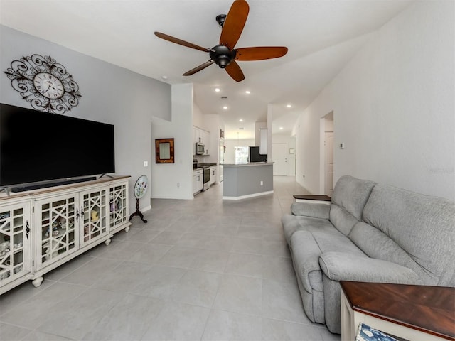 living room with baseboards, ceiling fan, vaulted ceiling, light tile patterned floors, and recessed lighting