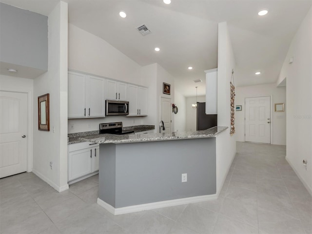 kitchen featuring light stone counters, visible vents, a peninsula, appliances with stainless steel finishes, and white cabinetry