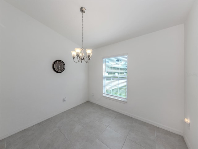 spare room featuring an inviting chandelier, light tile patterned floors, baseboards, and lofted ceiling