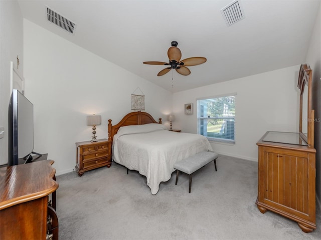 bedroom with light carpet, visible vents, baseboards, and vaulted ceiling