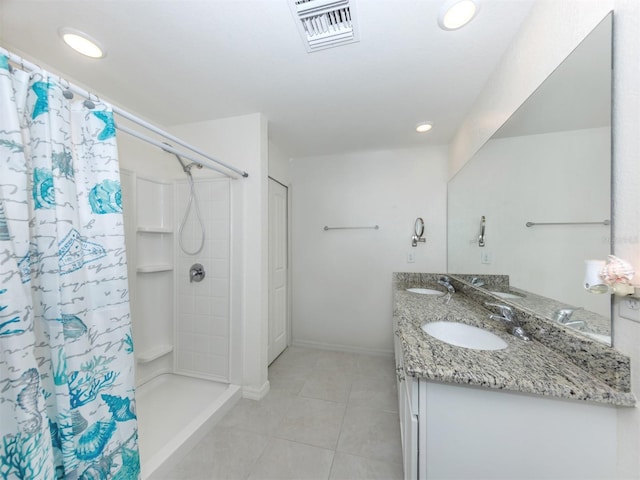 bathroom featuring a sink, visible vents, a shower with curtain, and tile patterned flooring