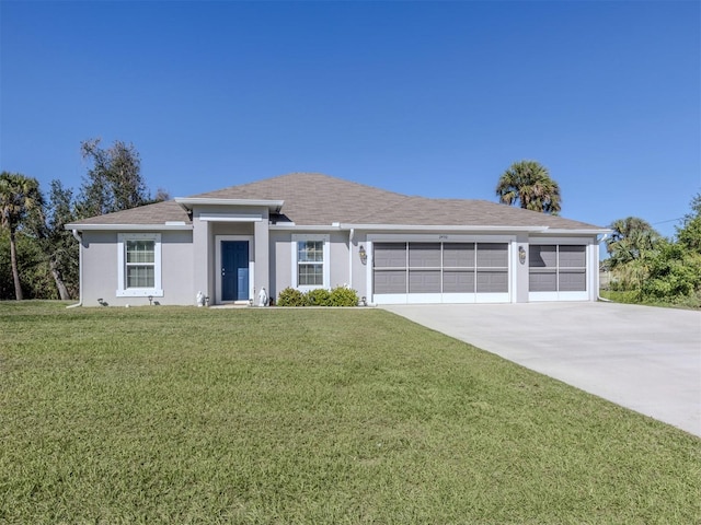 view of front of property featuring stucco siding, concrete driveway, a front yard, and a garage