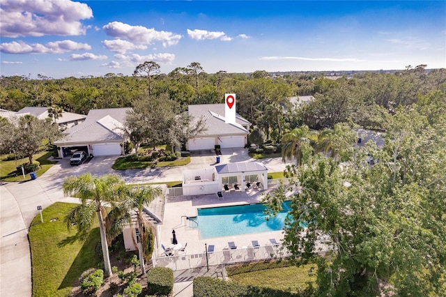 bird's eye view with a wooded view