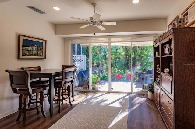 dining space with dark wood-style flooring, recessed lighting, visible vents, a ceiling fan, and baseboards