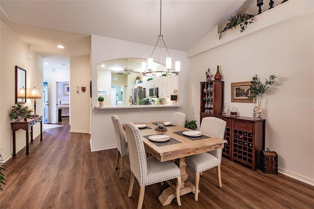 dining area with baseboards, arched walkways, and dark wood-type flooring