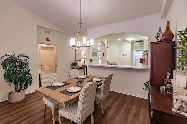 dining space featuring arched walkways, dark wood-style flooring, a notable chandelier, visible vents, and vaulted ceiling