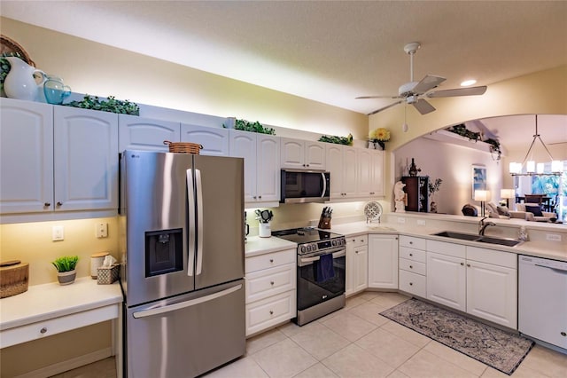 kitchen with stainless steel appliances, a sink, and light countertops