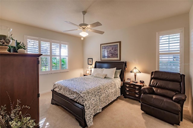 bedroom featuring ceiling fan, baseboards, and light colored carpet