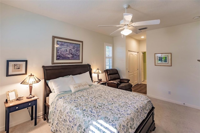 bedroom featuring carpet floors, a ceiling fan, visible vents, and baseboards