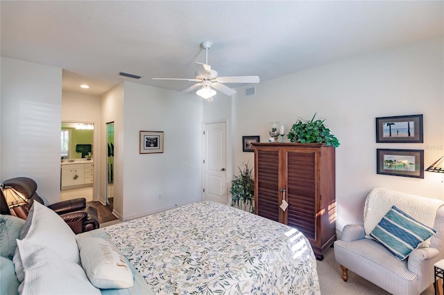 carpeted bedroom featuring ceiling fan, visible vents, and connected bathroom