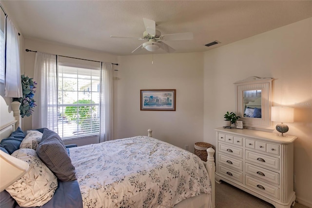 carpeted bedroom featuring visible vents and ceiling fan