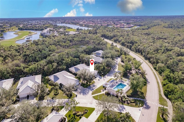 aerial view with a water view and a forest view