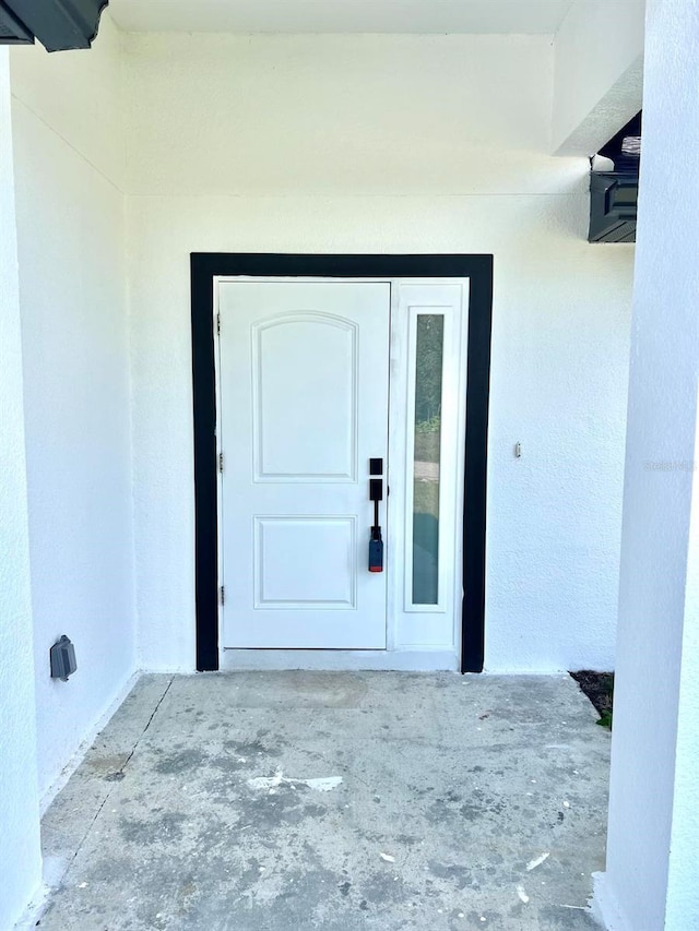 doorway to property with stucco siding