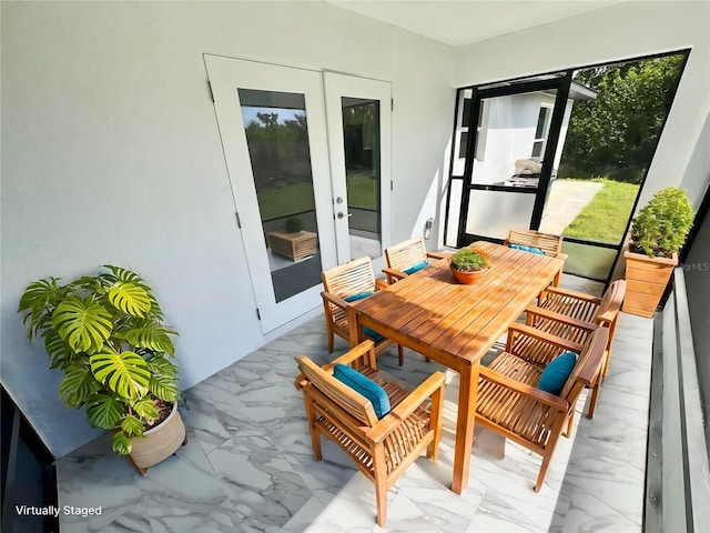 sunroom / solarium featuring french doors