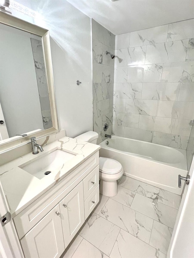 bathroom featuring toilet, marble finish floor, bathtub / shower combination, and vanity