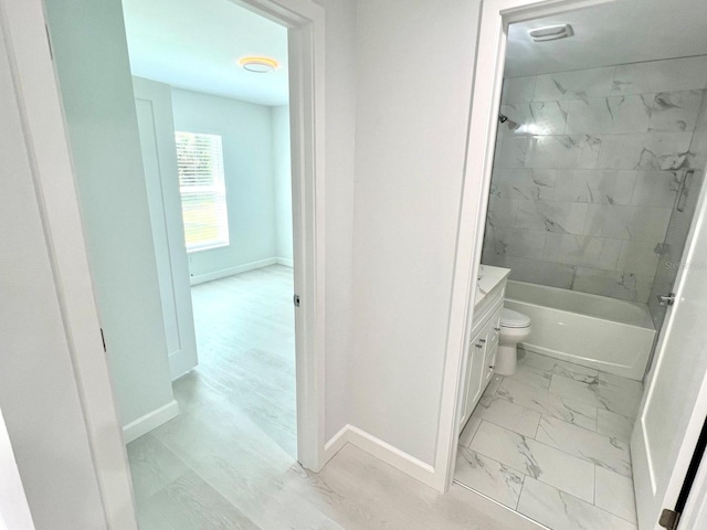 bathroom with marble finish floor, shower / bathing tub combination, and baseboards