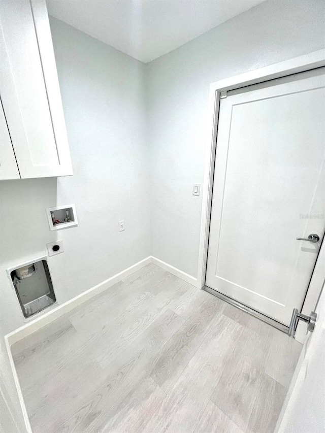 laundry room featuring hookup for a washing machine, baseboards, light wood-style floors, cabinet space, and electric dryer hookup