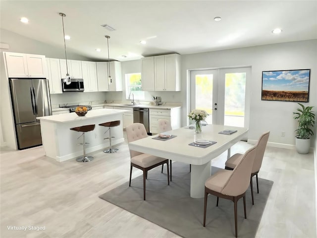 dining area with recessed lighting, baseboards, vaulted ceiling, french doors, and light wood finished floors