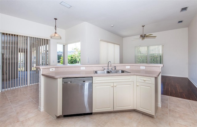 kitchen with a sink, visible vents, light countertops, and stainless steel dishwasher