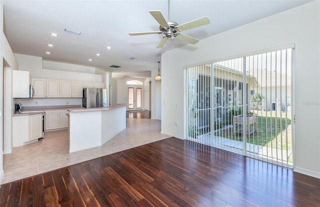 kitchen featuring light wood-style flooring, visible vents, white cabinets, light countertops, and appliances with stainless steel finishes