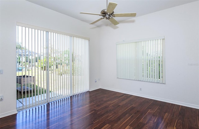 unfurnished room featuring plenty of natural light, baseboards, and wood finished floors