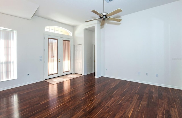 interior space featuring baseboards, wood finished floors, and french doors