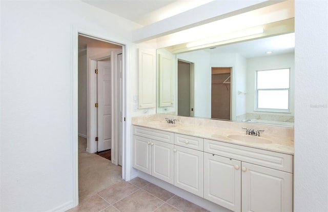 bathroom with double vanity, a sink, and tile patterned floors