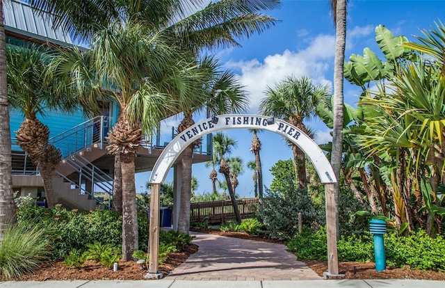 view of home's community featuring stairway and fence