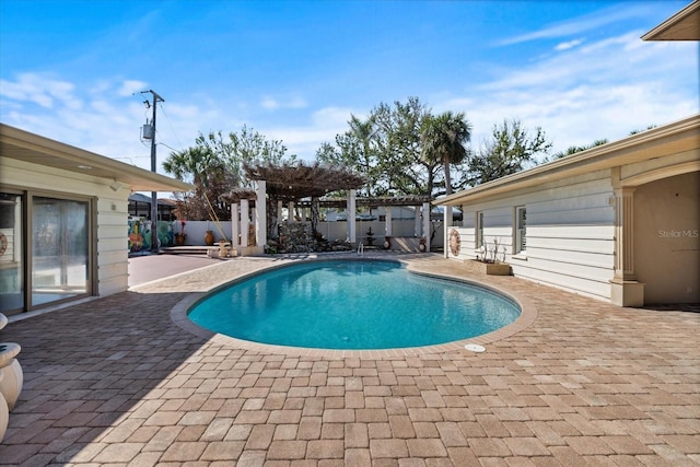 view of swimming pool with a patio, a fenced in pool, a fenced backyard, and a pergola