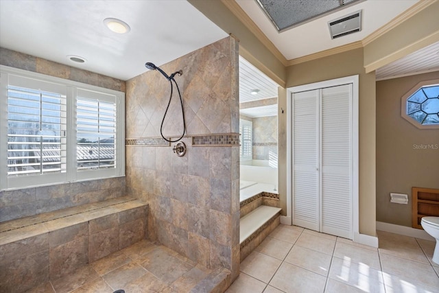 bathroom featuring toilet, a closet, ornamental molding, a tile shower, and a bath