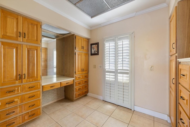 interior space featuring tile patterned floors, baseboards, and ornamental molding