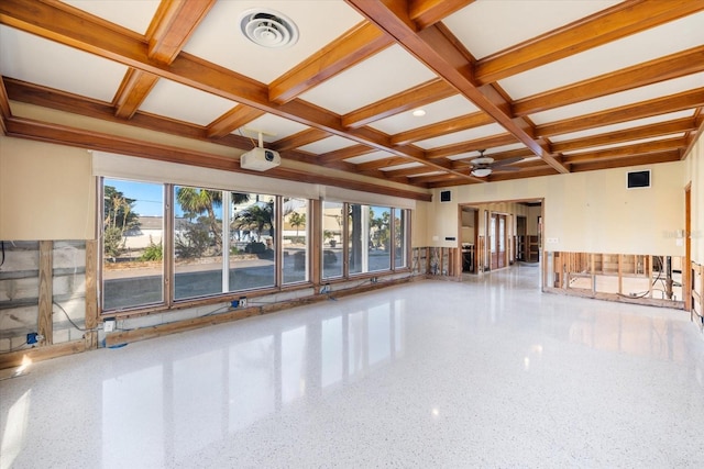 empty room with visible vents, a healthy amount of sunlight, coffered ceiling, and speckled floor