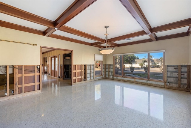 spare room with beamed ceiling, coffered ceiling, and speckled floor