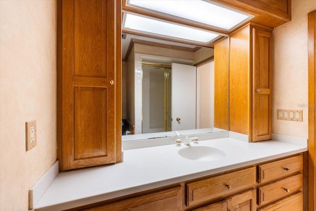 bathroom with a shower with door and vanity