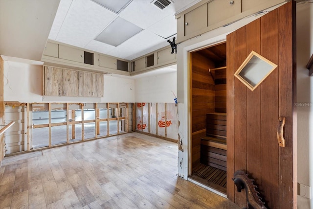 interior space with wood finished floors, visible vents, and a sauna